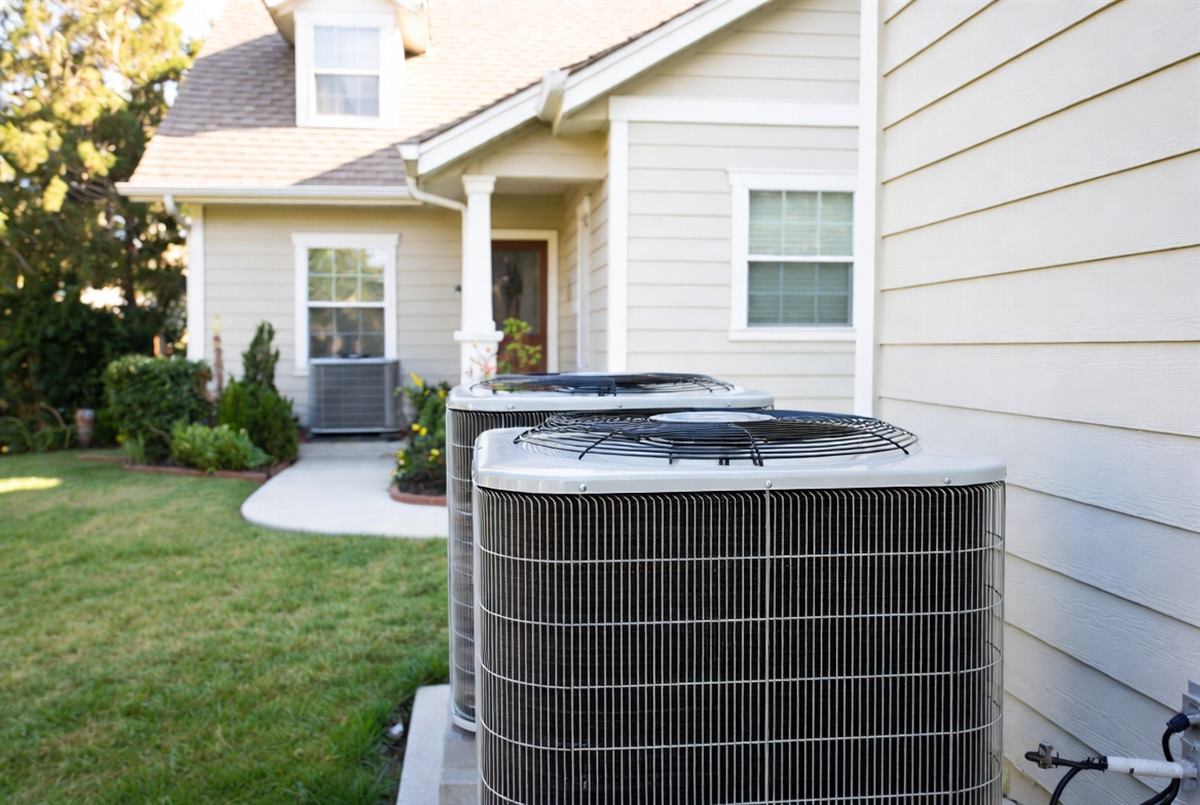 Outdoor air conditioner units beside a home