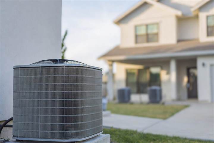 Air conditioner condenser outside a house