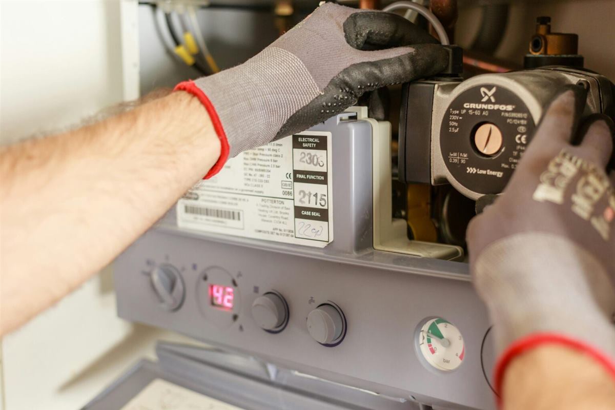 Technician servicing heating equipment
